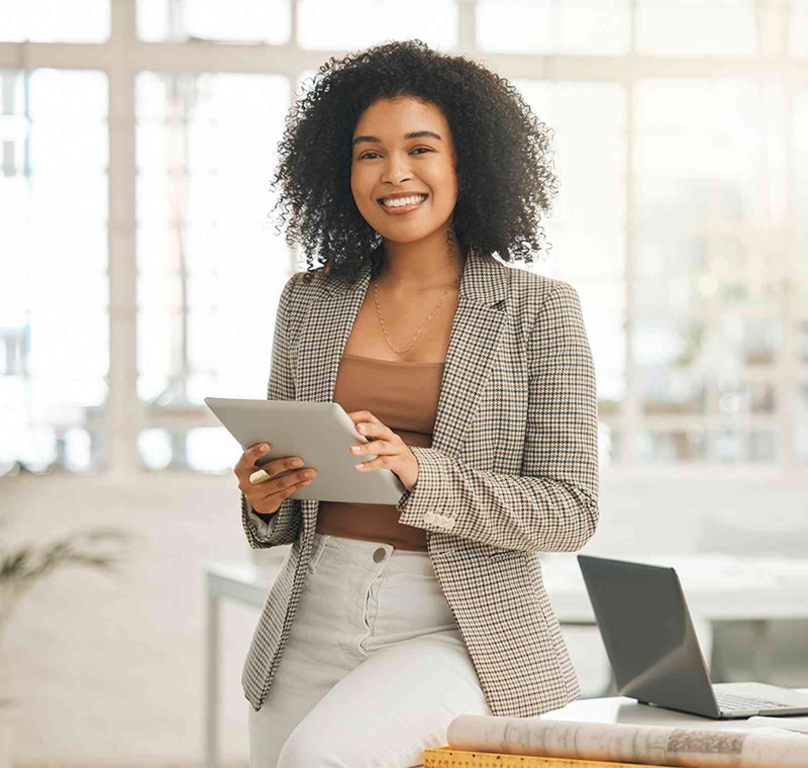 A project manager stands at a conference table reviewing charts and timelines with a team, coordinating project goals and milestones in a modern office environment.